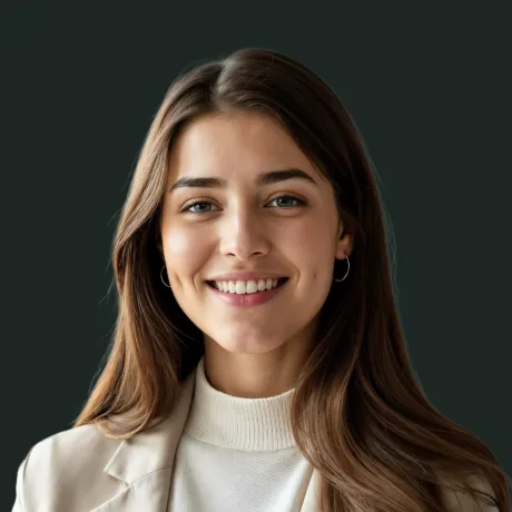 Smiling young woman with long brown hair wearing a white turtleneck and beige blazer against a dark background.